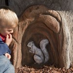A squirrel built into the tree house play structure on an inclusive playground